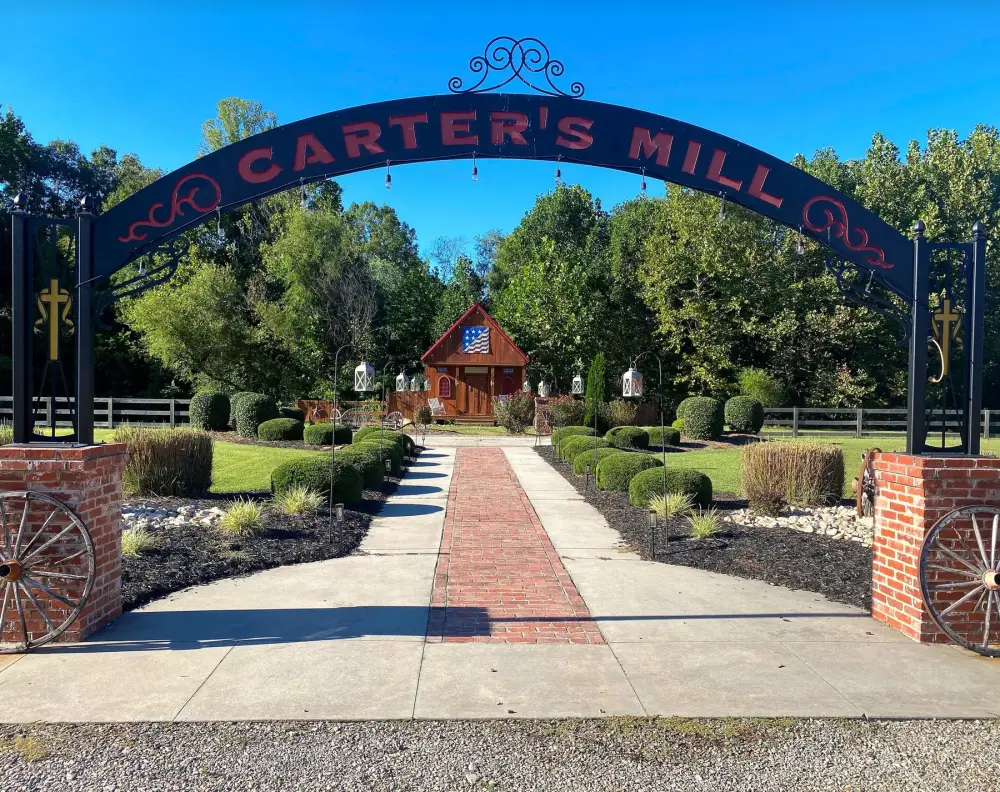 The Carter's Mill arch over the brick path, with the little chapel behind it